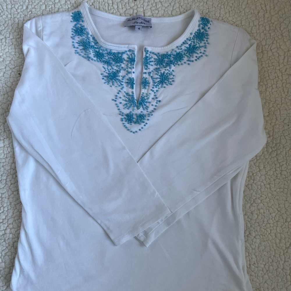Beautiful top with blue beads. Runs small for size 4.